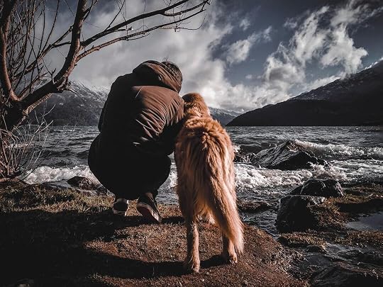man and a dog on a lakeside