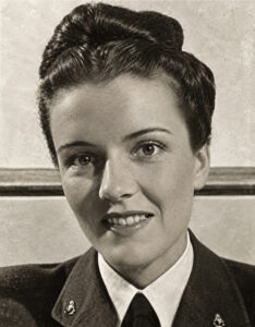 Attractive dark-haired woman, smiling, wearing British Women's Air Force uniform