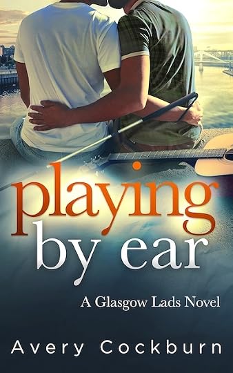 Book cover: Playing by Ear: A Glasgow Lads Novel by Avery Cockburn. Two men embrace sitting on the edge of the River Clyde in Glasgow, Scotland. Behind them lies an acoustic guitar. The man on the left, wearing a plain white T-shirt, holds a white cane behind him with its loop around his wrist. The man on the right wears a green plaid T-shirt. Their faces are not fully visible but it’s clear they’re kissing. In the background, the sun shines brilliantly.