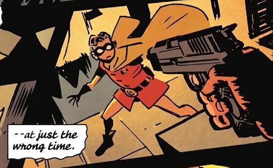 Robin stands in apprehension as the criminal points a gun at him