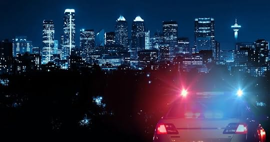 calgary skyline with police car and lights in front