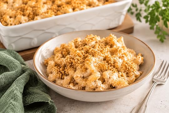 Creamy vegan mac and cheese bake with golden breadcrumb topping served on a white plate.