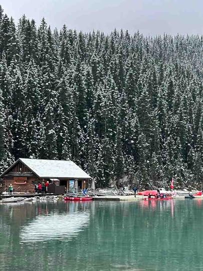 boathouse with canoes on an emerald coloured lake