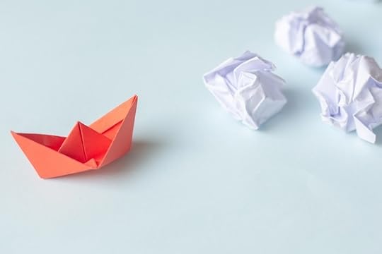 red paper boat with white crumpled paper