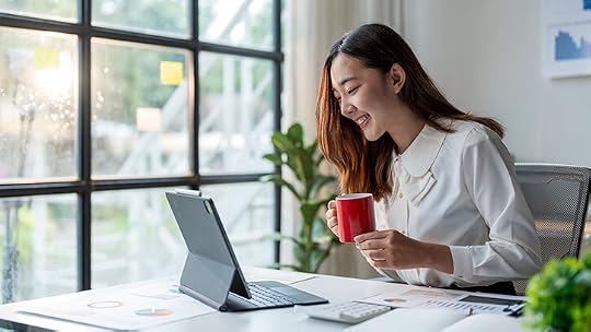 Smiling Woman Enjoying Coffee While Working