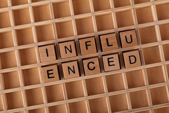 Wooden Scrabble tiles spelling 'Influenced' on a wooden grid background by Ann H from Pixels